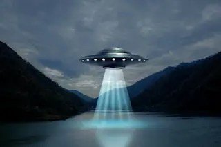 Alien spaceship, UFO, emitting light beam in air over lake