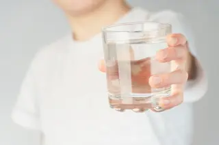 A child holding a cup of water.
