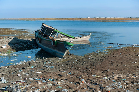 Abandoned boats on the receding shoreline of the Euphrates River in the South of Iraq