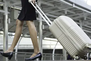 woman suitcase airport shutterstock
