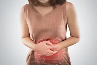 upset stomach IBD and IBS symptoms - Shutterstock