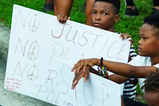 protest child sign racism - shutterstock
