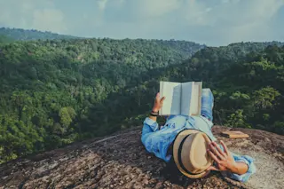 book reader mountains - shutterstock