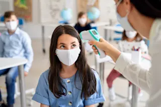 coronavirus student teenager child temperature check school - shutterstock