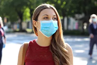 Coronavirus woman mask outdoors - shutterstock