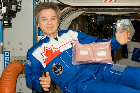 Astronaut with tomato seeds in space - NASA