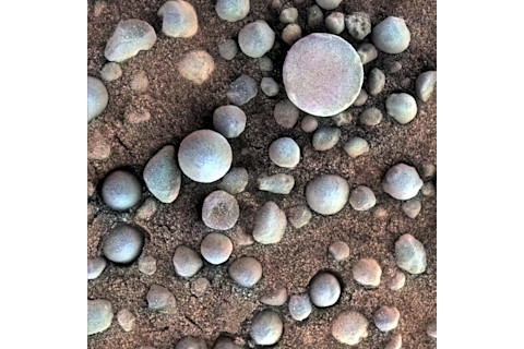 a pile of small round blue stones