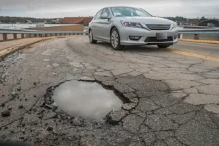 Potholes in the road - shutterstock