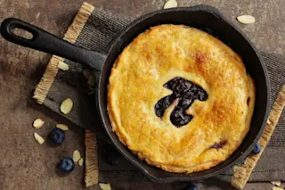 pi symbol in a pie baked in a cast iron skillet fro pi day