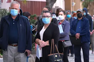 senior residents in los angeles waiting for their covid-19 vaccine - shutterstock