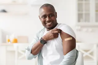 vaccine band aid smiling man -m shutterstock 1942433743