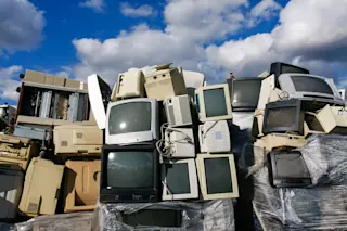old tvs stacked up - shutterstock