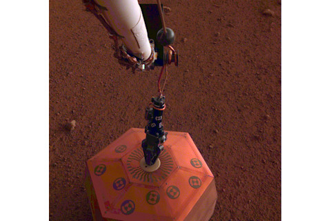 NASA's Insight lander placing a seismometer on the surface of Mars. NASA.