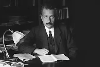Einstein at his desk - wikimedia commons 
