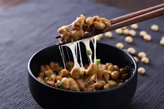 bowl of natto with chopsticks - shutterstock 1140852635