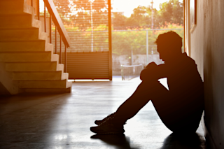 Silhouette of a sad man at sunset