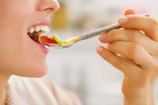 sense of taste woman is eating fruit - shutterstock 143921158