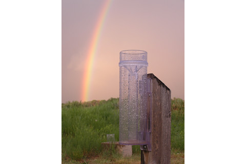 CoCoRaHS rain gauge and rainbow