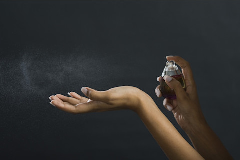 Applying Perfume to Wrist - Shutterstock