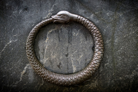 Bas-relief of ouroboros, a snake biting its own tail