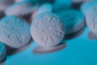 White aspirin tablets with blue background 