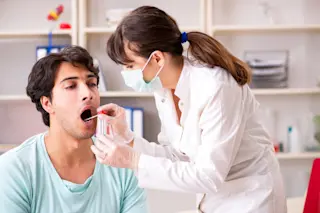 Doctor getting saliva test sample in clinic hospital