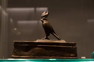 Leiden, The Netherlands - JAN 26, 2019: small bird coffin with a statue of Horus as a falcon from ancient Egypt. Sarcophagus.