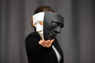 Theatre actor holding drama and comedy mask 