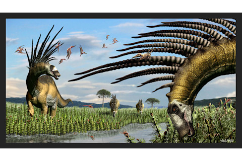 Jorge A. González. A group of Bajadasaurus on the side of a water course