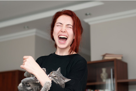 Cat biting a woman's arm