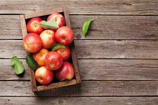 Ripe red apples in wooden box. Top view with space for your text