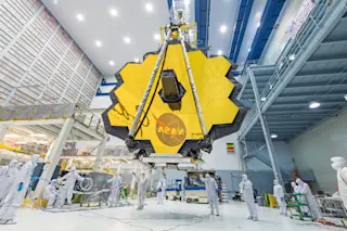 James Webb Space Telescope mirror with scientists