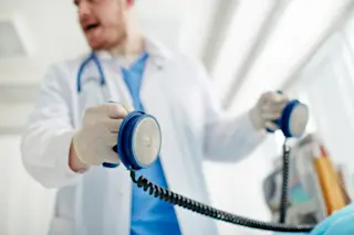Doctor with defibrallator in hands. Cardiac arrest