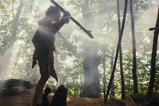 A Nomad wearing an animal skin while holding a stone tipped spear