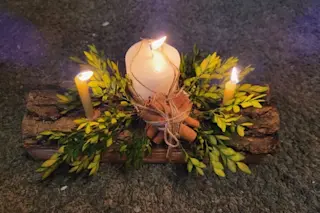 yuel log with greenery and candle