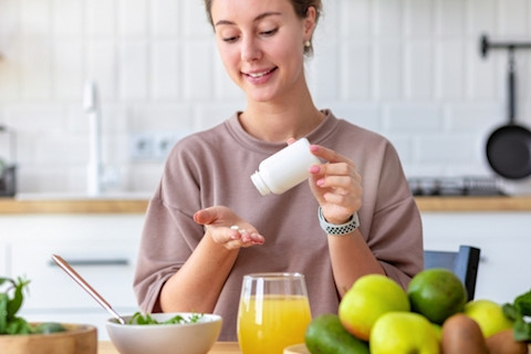 woman taking medication with food