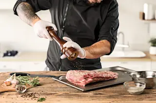 Man cooking meat for carnivore diet