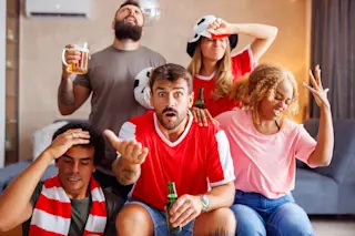 Angry sports fans watching game on TV