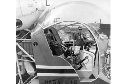 Neil, rocking shades, approaches an early prototype of the LLRV. NASA