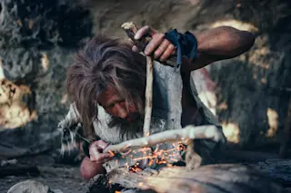 caveman starting a fire
