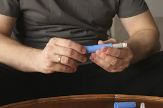 Man preparing Semaglutide Ozempic injection to control blood sugar levels