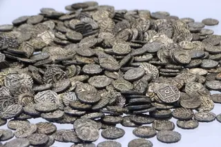pile of ornate silver coins
