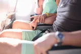 couple holding the arm rests of an airplane during turbulence 
