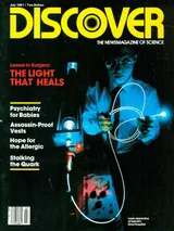 The cover image of the July 1981 issue of Discover Magazine, showing a man in a dark room holding a glowing cable from a laser apparatus