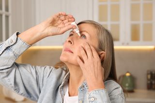 Woman putting in eye drops Woman putting in eye drops