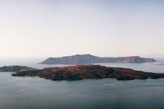 the volcano of Santorini island in Cyclades, Greece as seen from a distance 