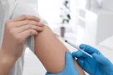 someone getting a shot from a medical professional 