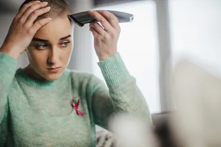 Young woman shaving hair before chemo Young woman shaving hair before chemo