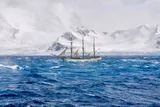A three masted schooner sails in the Antarctic similar to Shackleton's Endurance 