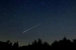 A meteor streaking across the night sky A meteor streaking across the night sky